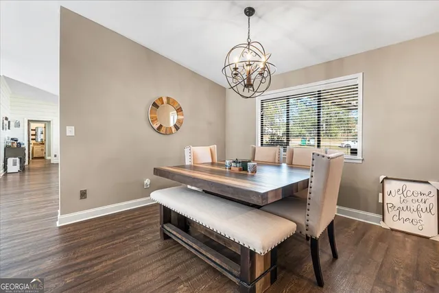 a view of a dining room with furniture wooden floor and chandelier
