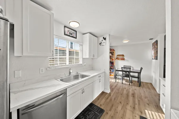 a kitchen that has a sink and chairs