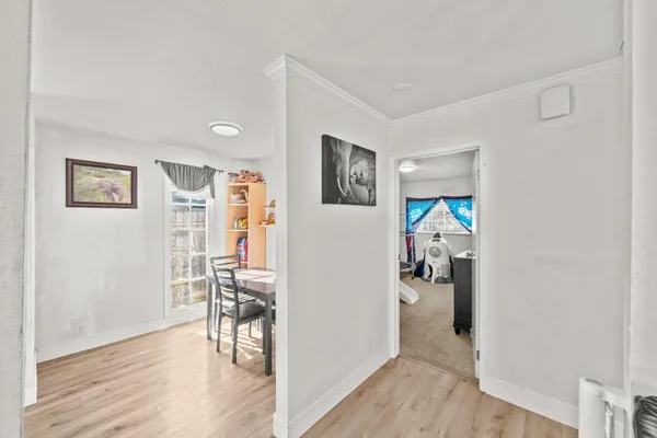 a view of a livingroom with wooden floor and furniture