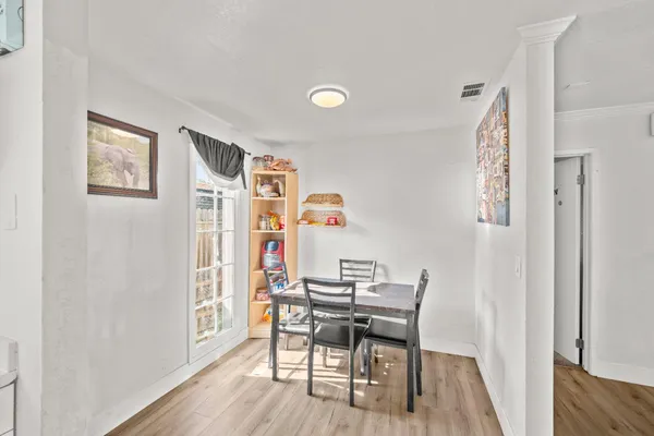 a dining room with furniture and wooden floor