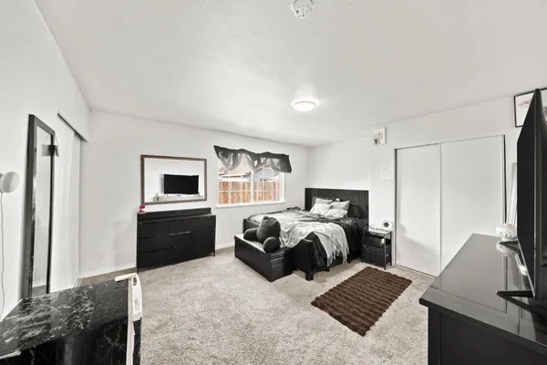 a bedroom with a bed and a couch