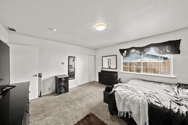 a bedroom with a bed and a television