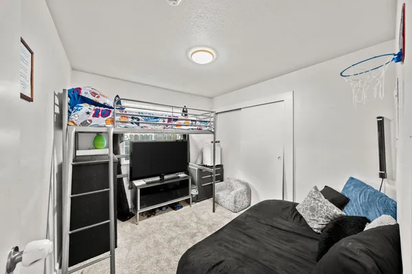 a bedroom with a bed and a flat screen tv