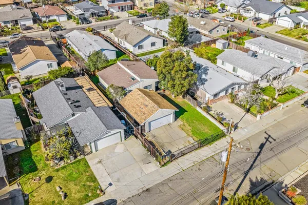 an aerial view of a residential houses with yard