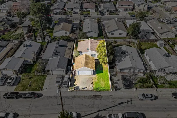 an aerial view of residential houses with outdoor space