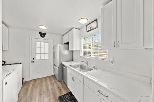 a kitchen with a sink cabinets and window