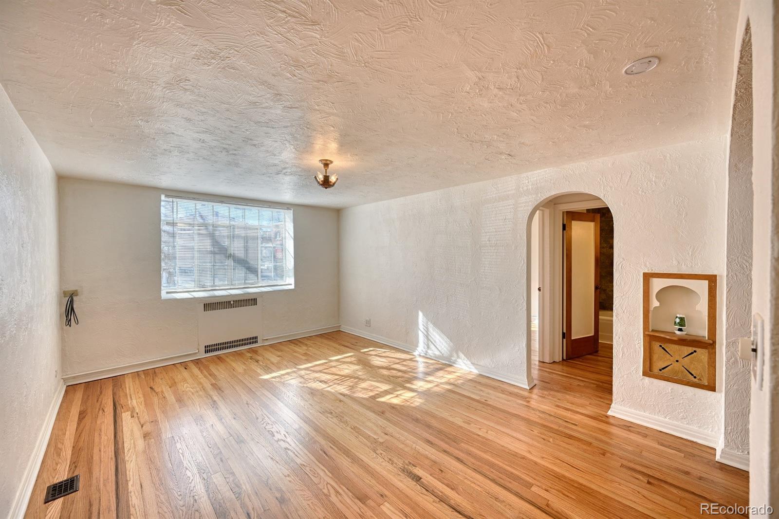485 South Logan Street, Unit 16 Denver, CO 80209 - Photo 7 of 14 a view of empty room with wooden floor