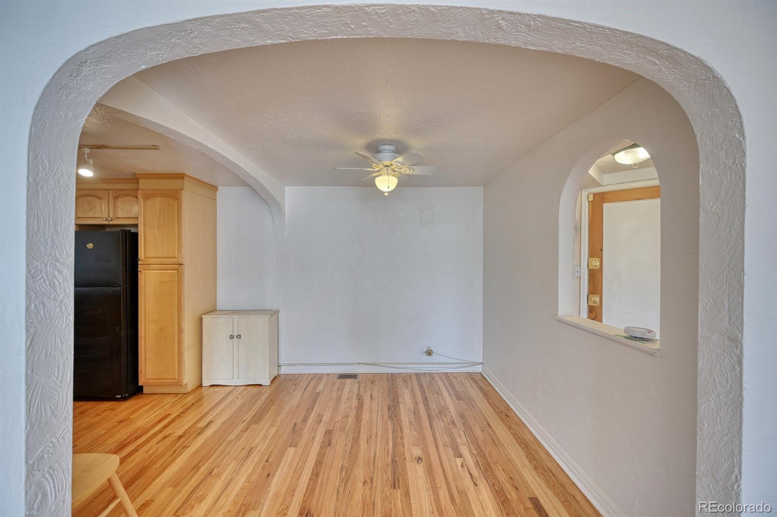 485 South Logan Street, Unit 16 Denver, CO 80209 - Photo 9 of 14 a view of a livingroom with wooden floor and a window