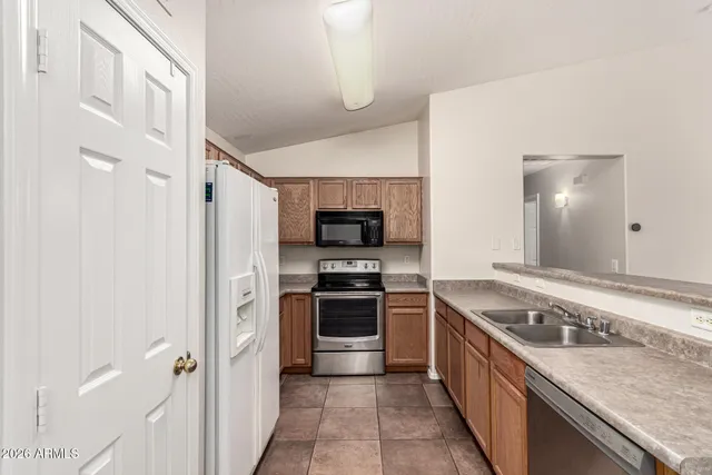 a kitchen with a stove and a refrigerator