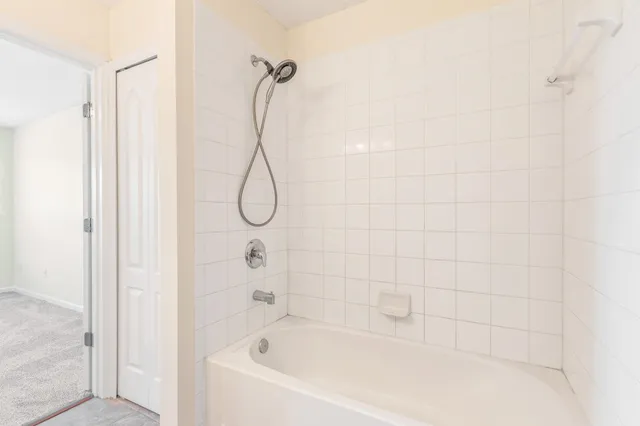 a bathroom with a bath tub with a shower
