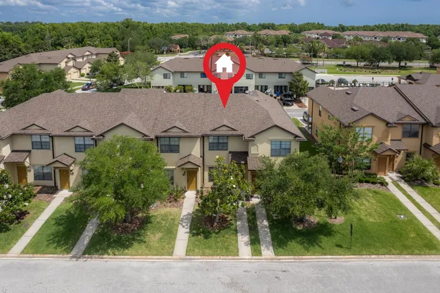 an aerial view of a house with swimming pool garden and patio