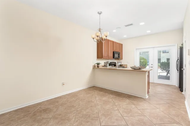 a view of kitchen with refrigerator and window