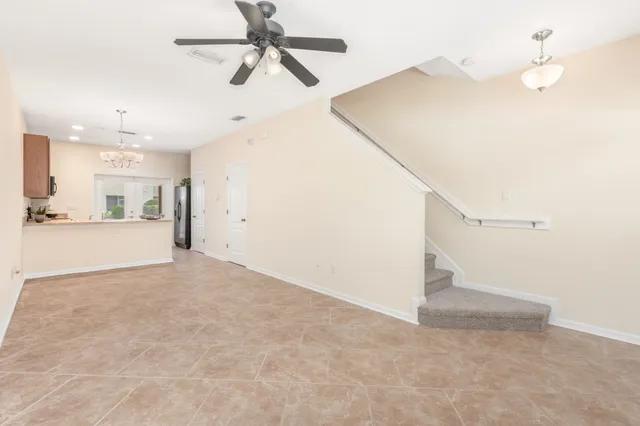 a view of a big room with closet and a ceiling fan