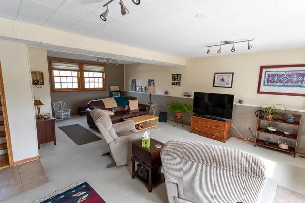 a bedroom with furniture and a flat screen tv