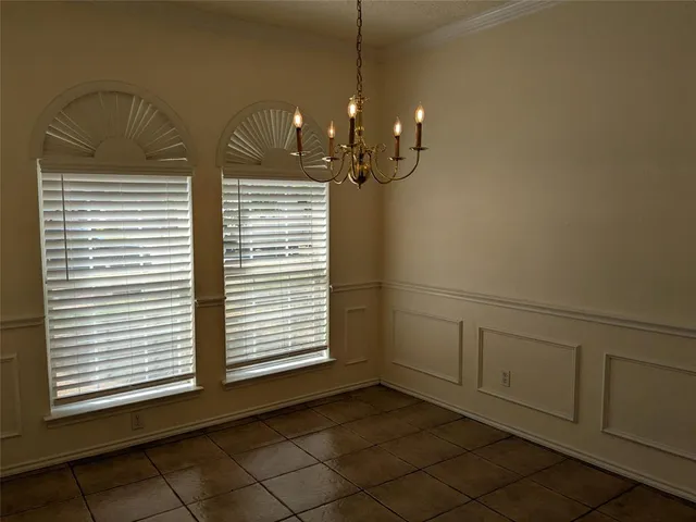 a view of a livingroom with a chandelier fan and a window