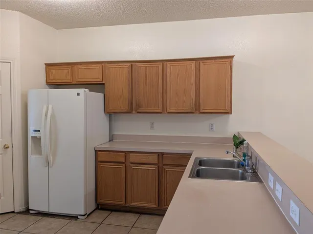a kitchen with stainless steel appliances a refrigerator and cabinets