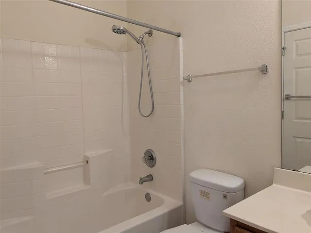 a bathroom with a shower a toilet and a shower