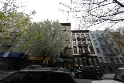 a city street lined with buildings and trees