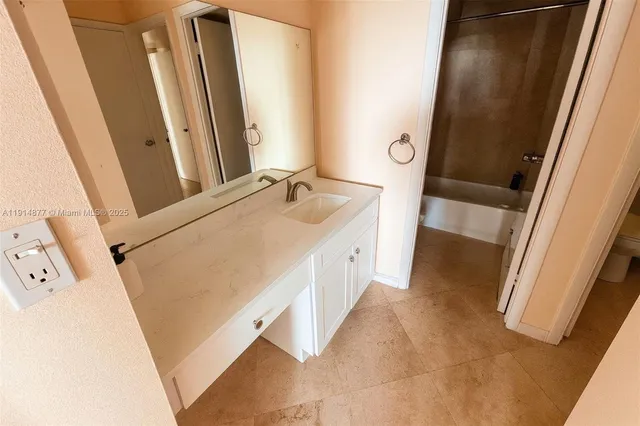 a bathroom with a sink mirror vanity and a toilet