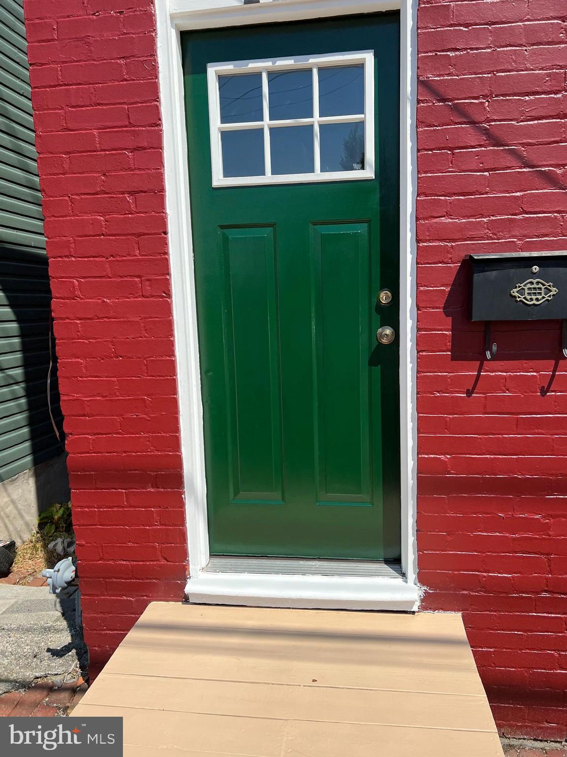 a view of a brick house with a green door