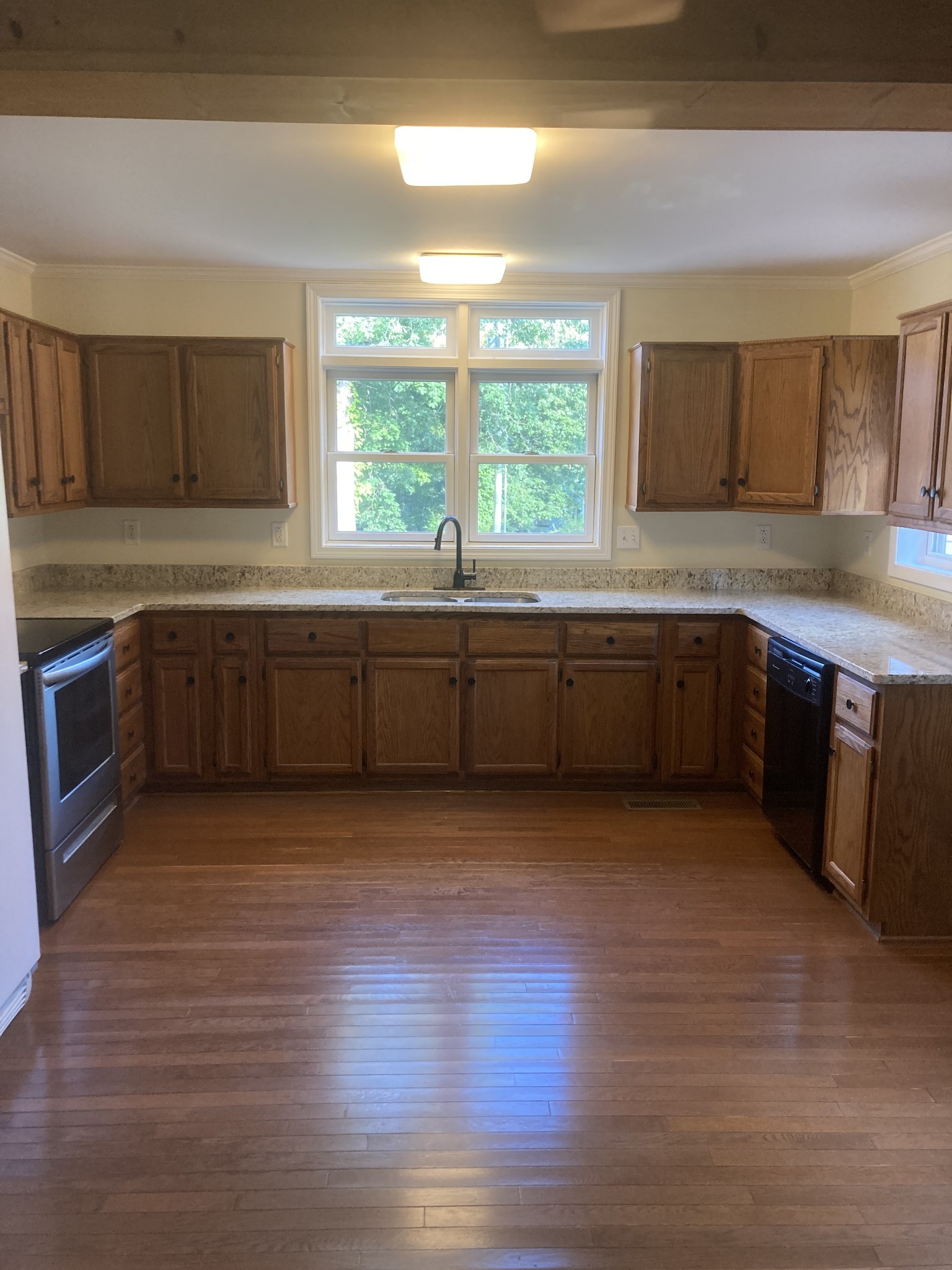 4516 Mansford Road Winchester, TN 37398 - Photo 42 of 53 a large kitchen with wooden floor and stainless steel appliances