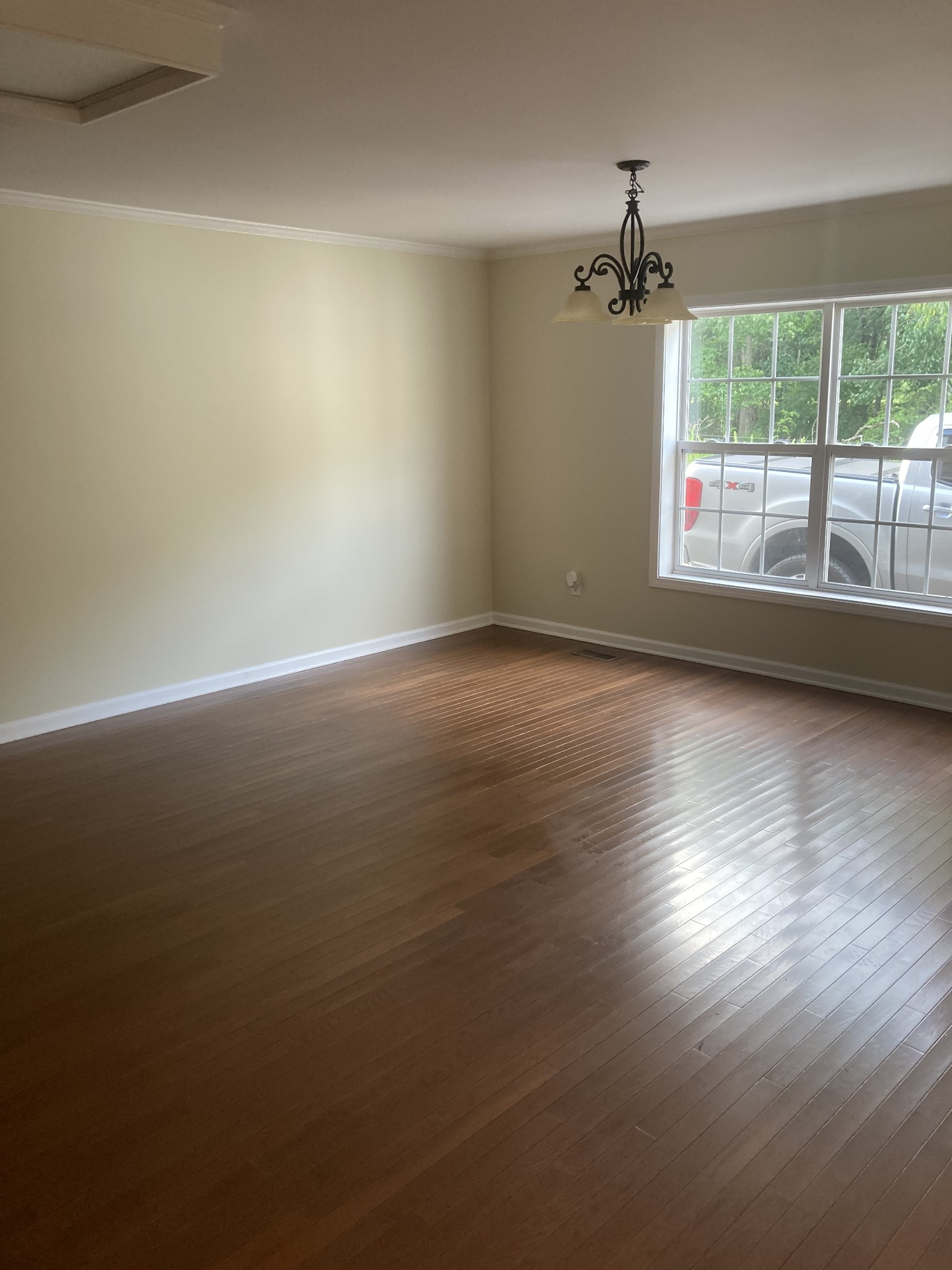 4516 Mansford Road Winchester, TN 37398 - Photo 6 of 53 an empty room with wooden floor chandelier and windows