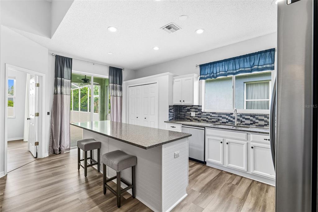 10443 Peppergrass Court Trinity, FL 34655 - Photo 12 of 62 a kitchen with a sink and chairs