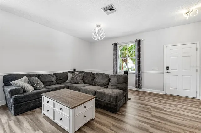 a kitchen with stainless steel appliances kitchen island granite countertop a stove a sink and a refrigerator