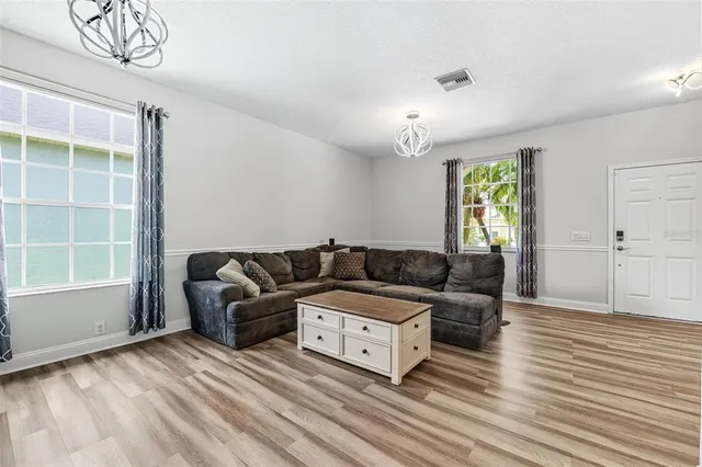 a spacious bedroom with a bed and a flat screen tv