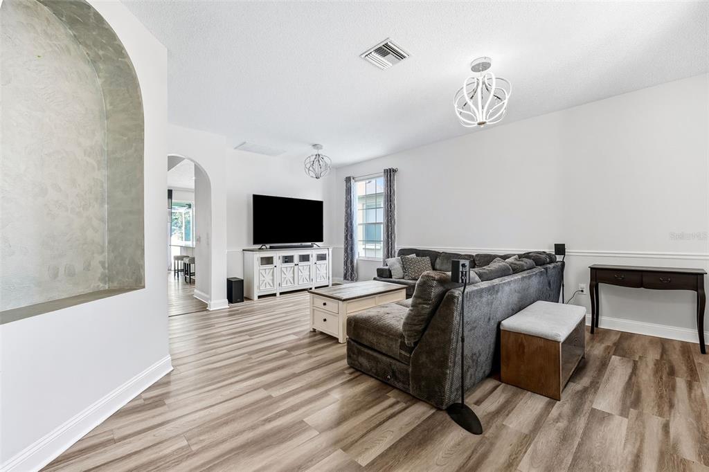 10443 Peppergrass Court Trinity, FL 34655 - Photo 20 of 62 a living room with furniture and a flat screen tv