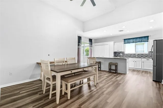 a bathroom with a tub a sink and a window