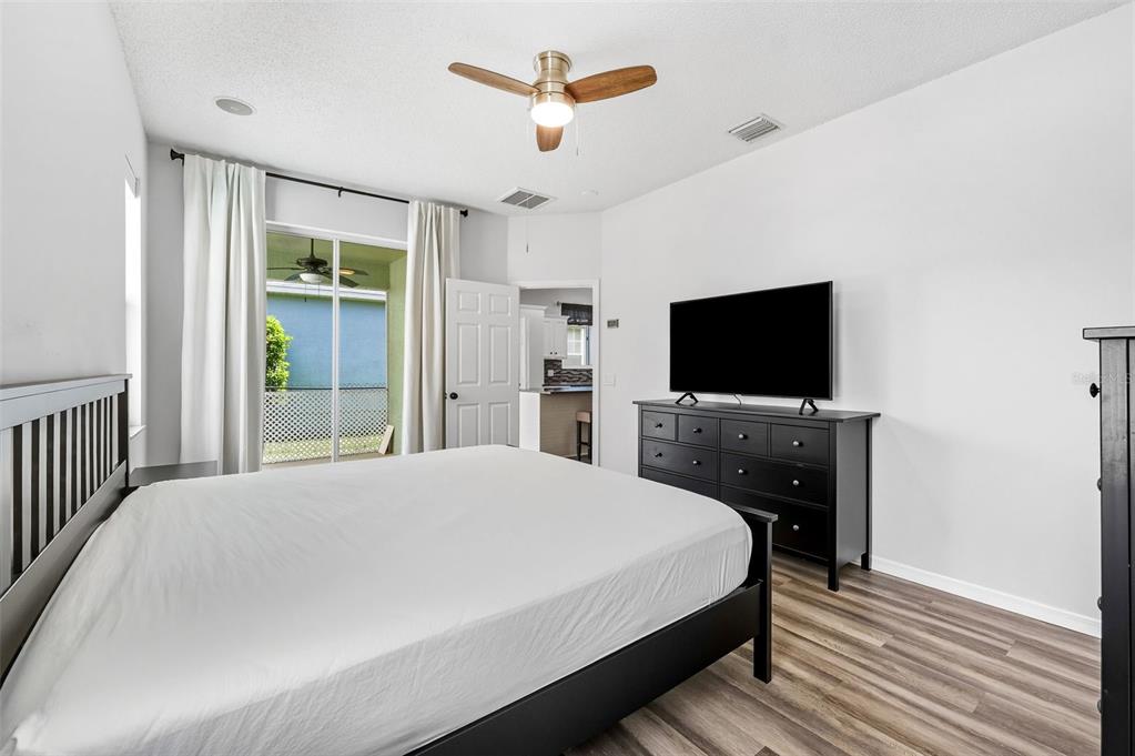 10443 Peppergrass Court Trinity, FL 34655 - Photo 25 of 62 a bedroom with a bed and a flat screen tv