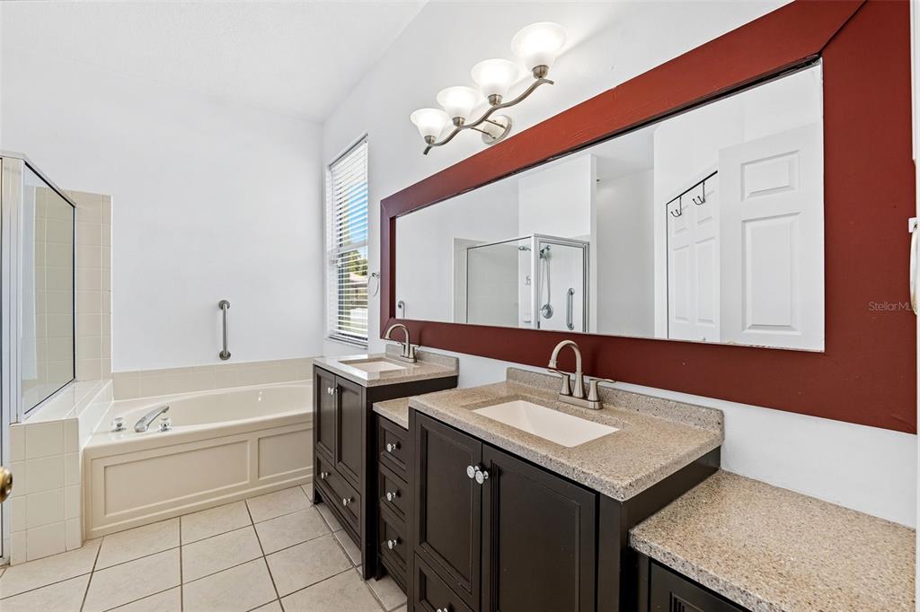 10443 Peppergrass Court Trinity, FL 34655 - Photo 26 of 62 a bathroom with a sink a vanity and a mirror