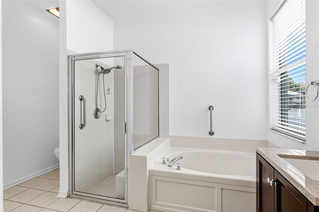 10443 Peppergrass Court Trinity, FL 34655 - Photo 27 of 62 a bathroom with a tub a sink and a window