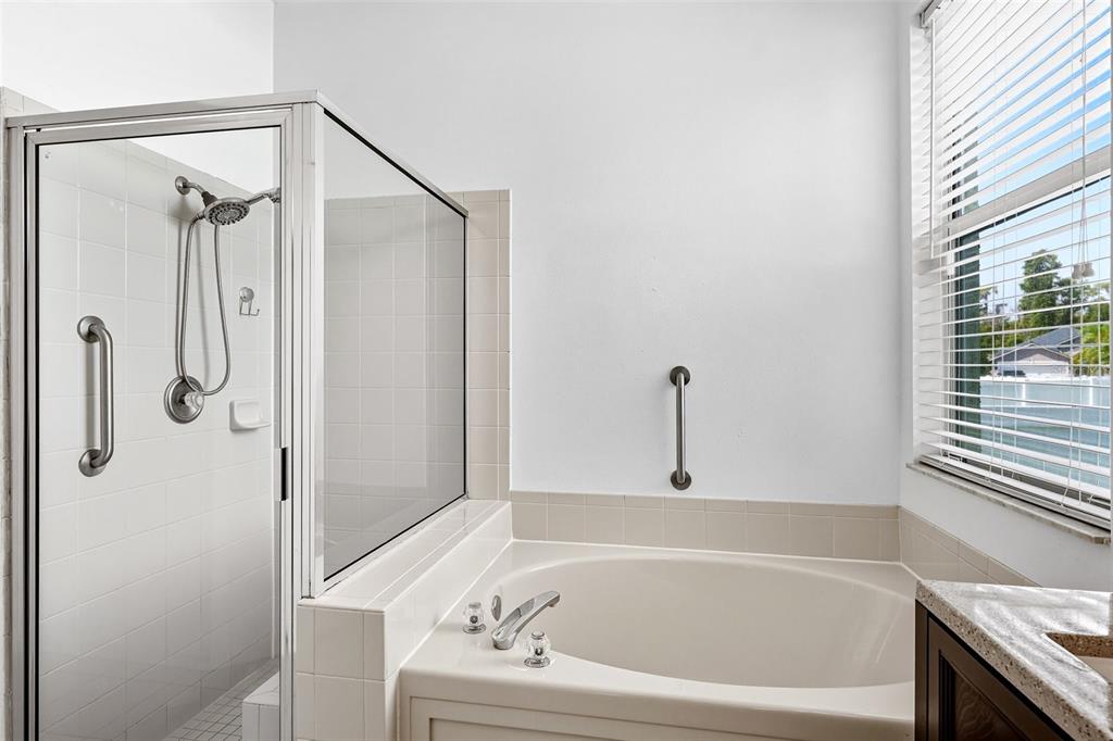 10443 Peppergrass Court Trinity, FL 34655 - Photo 29 of 62 a bathroom with a bathtub and a shower