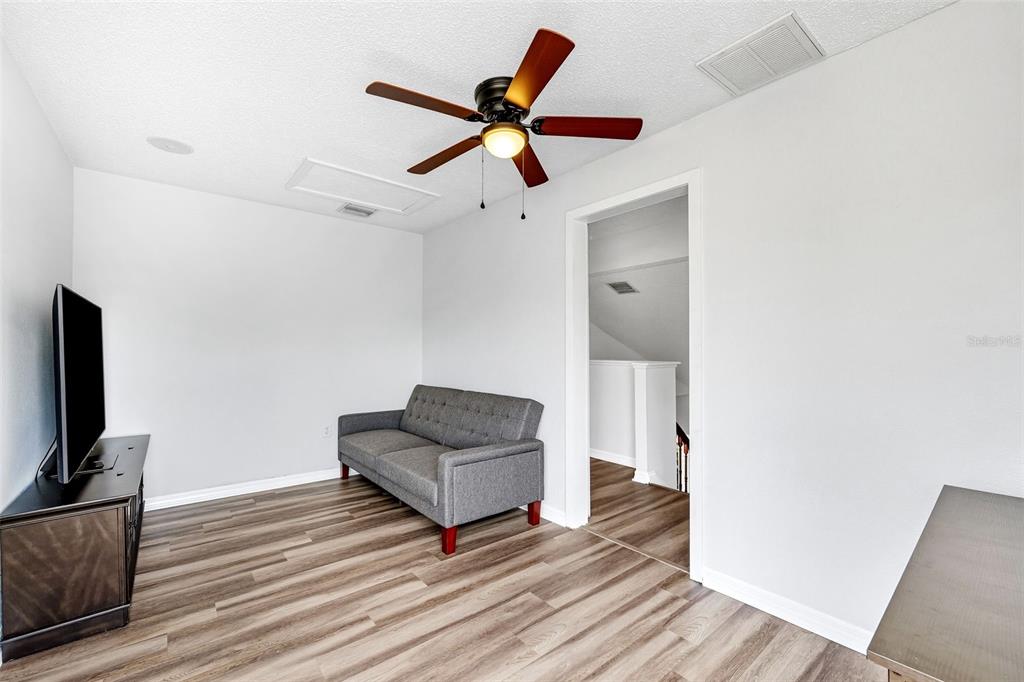 10443 Peppergrass Court Trinity, FL 34655 - Photo 33 of 62 a living room with couch and a ceiling fan