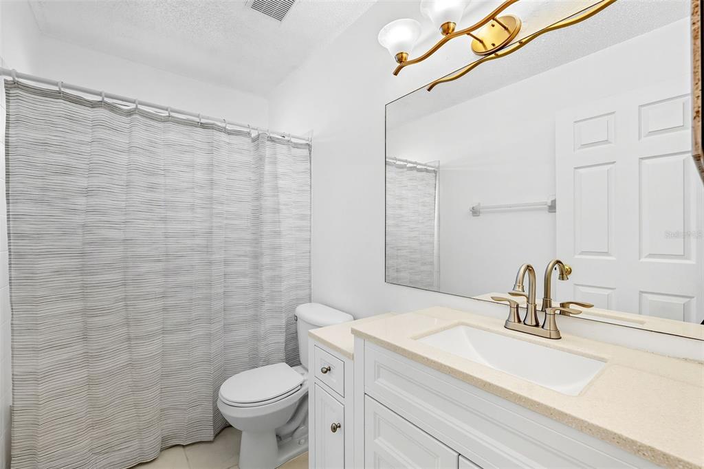 10443 Peppergrass Court Trinity, FL 34655 - Photo 37 of 62 a bathroom with a sink a toilet and a mirror