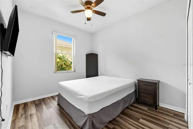 a view of a backyard with table and chairs under an umbrella