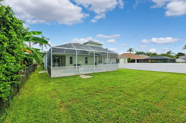 an aerial view of residential houses with outdoor space and a lake view