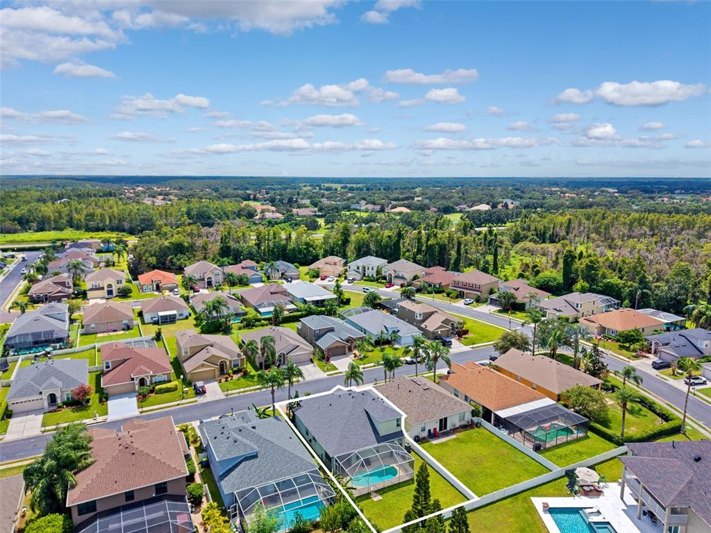 10443 Peppergrass Court Trinity, FL 34655 - Photo 54 of 62 an aerial view of a city with lots of residential buildings and mountain view in back