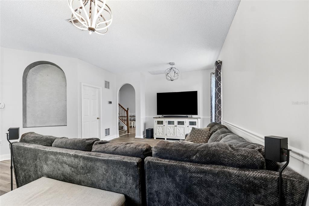 10443 Peppergrass Court Trinity, FL 34655 - Photo 6 of 62 a living room with furniture and a flat screen tv