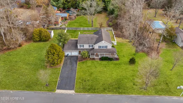 a aerial view of a house with a yard basket ball court and outdoor seating