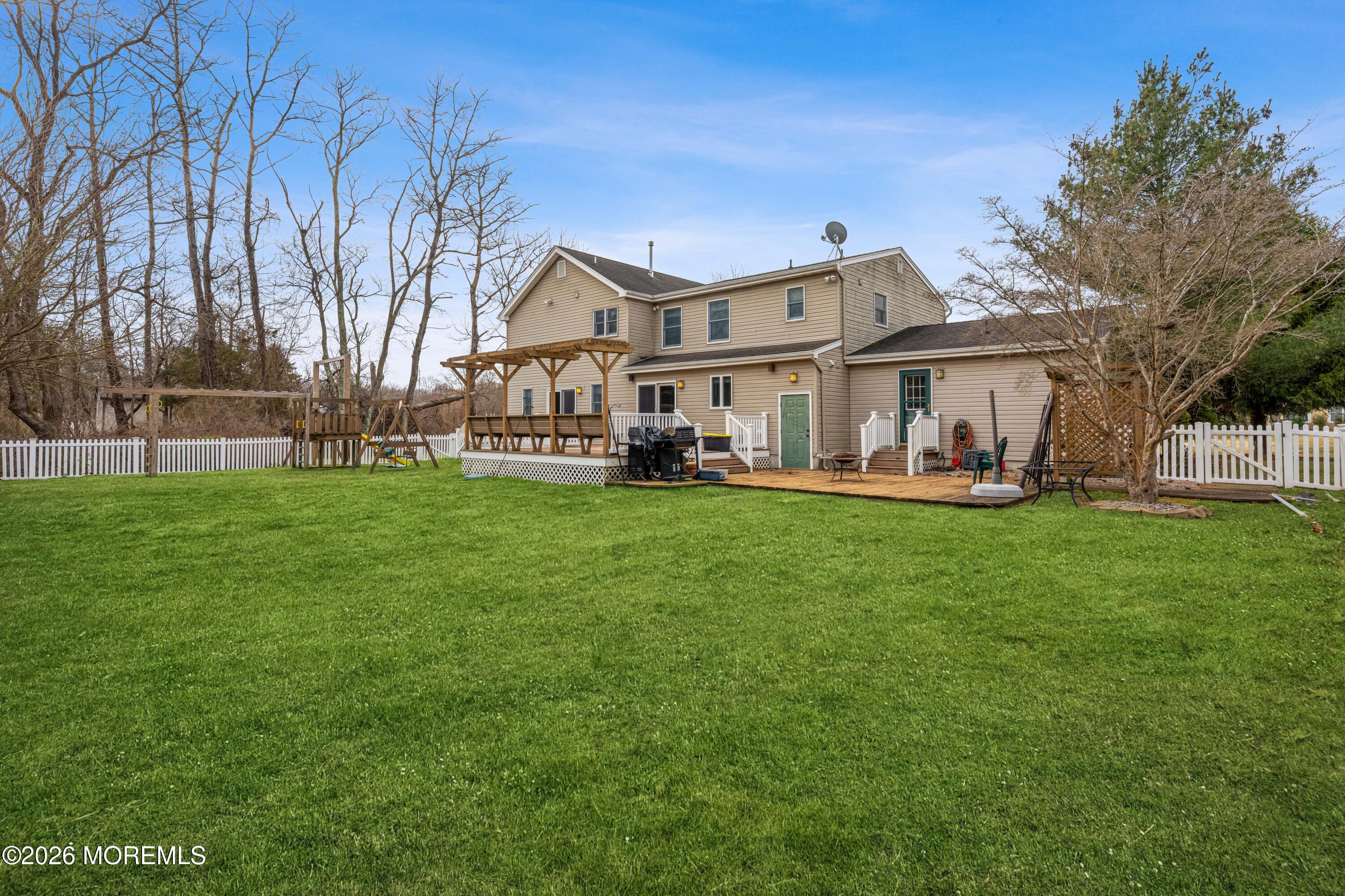 1 Kari Court Jackson, NJ 08527 - Photo 16 of 66 a front view of a house with a garden and trees