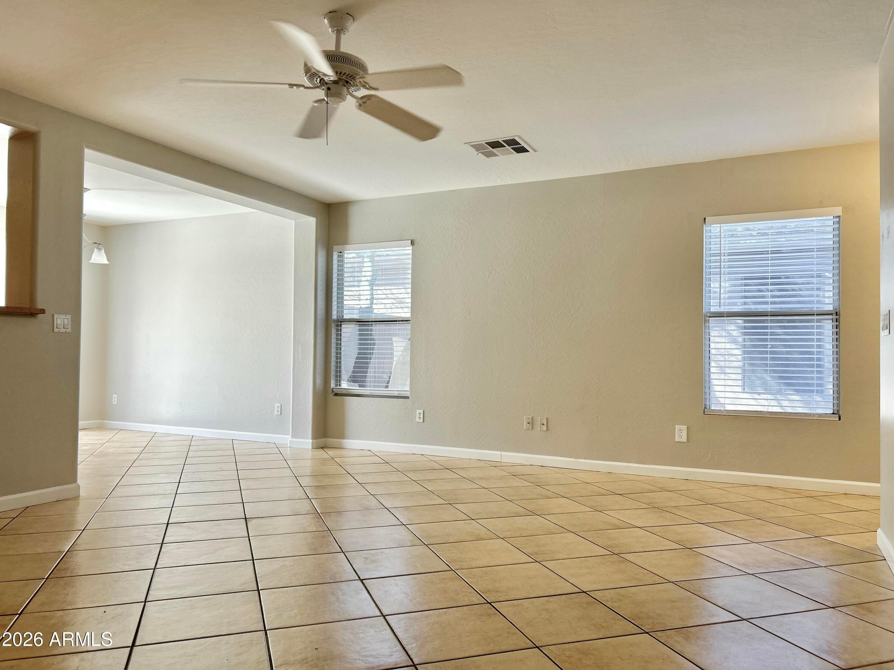2701 East Bagdad Road San Tan Valley, AZ 85143 - Photo 6 of 21 a view of an empty room with window and chandelier fan