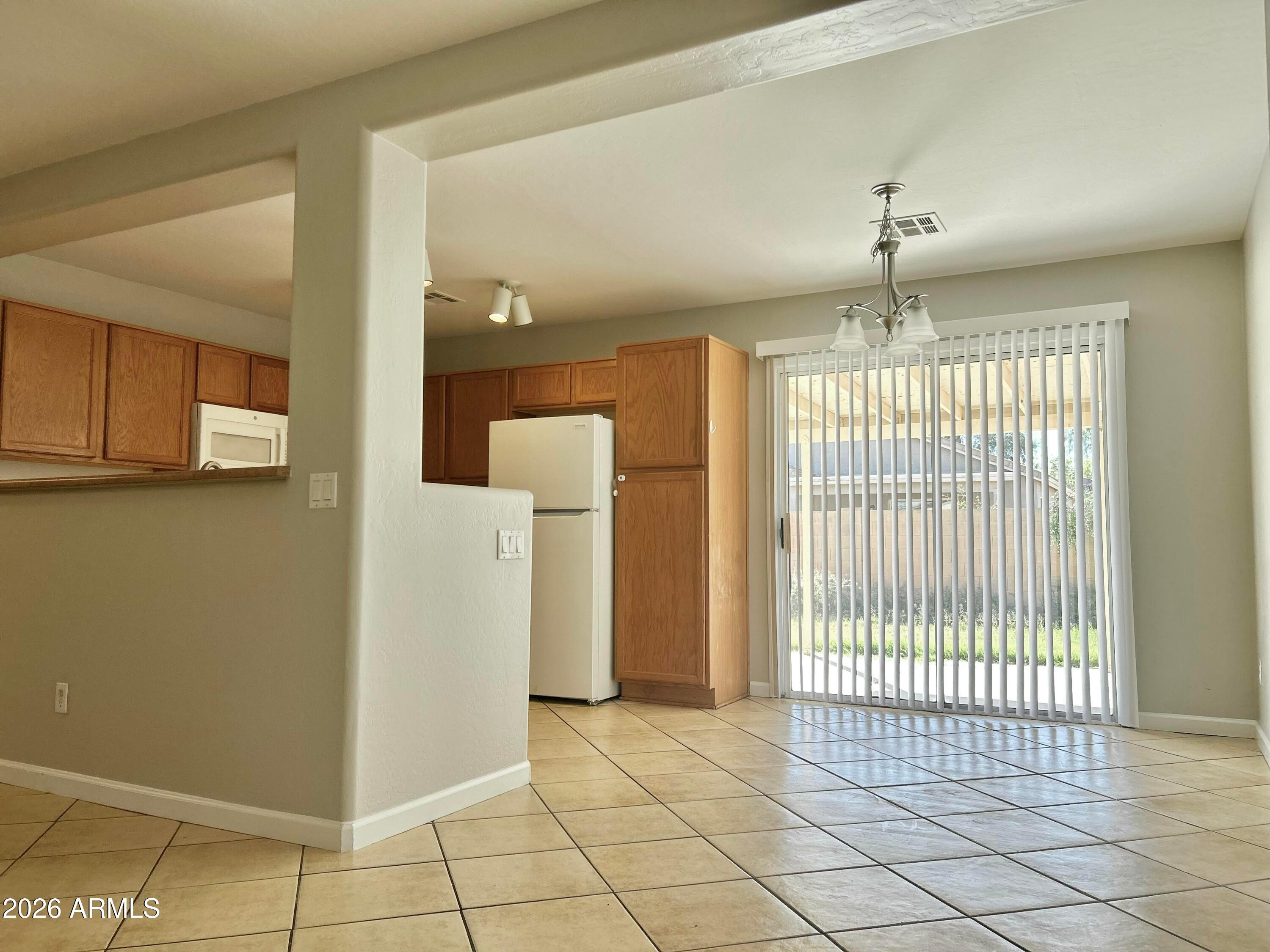 2701 East Bagdad Road San Tan Valley, AZ 85143 - Photo 7 of 21 a view of a livingroom with an empty space and chandelier
