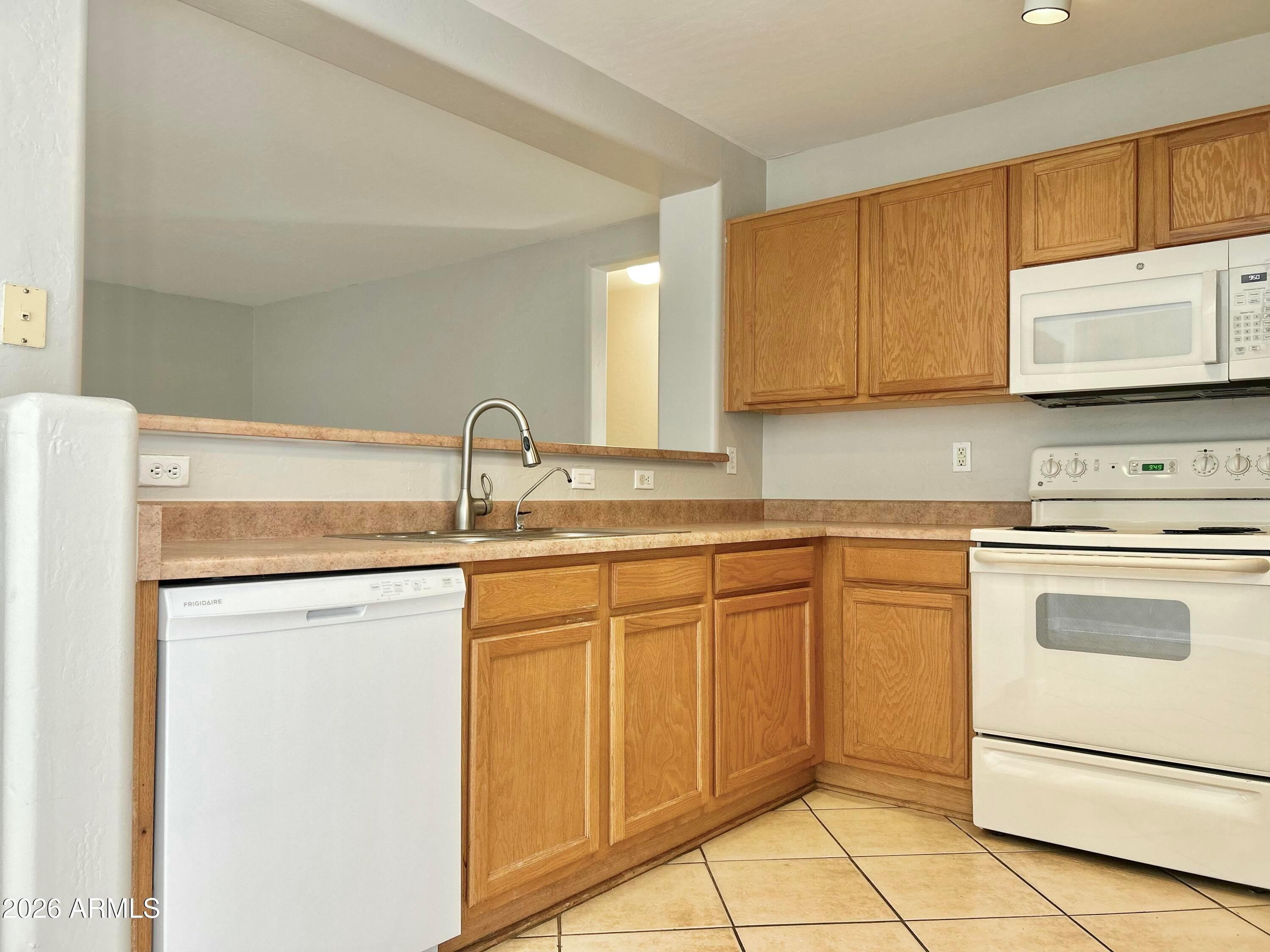 2701 East Bagdad Road San Tan Valley, AZ 85143 - Photo 9 of 21 a kitchen with granite countertop cabinets stainless steel appliances and a sink