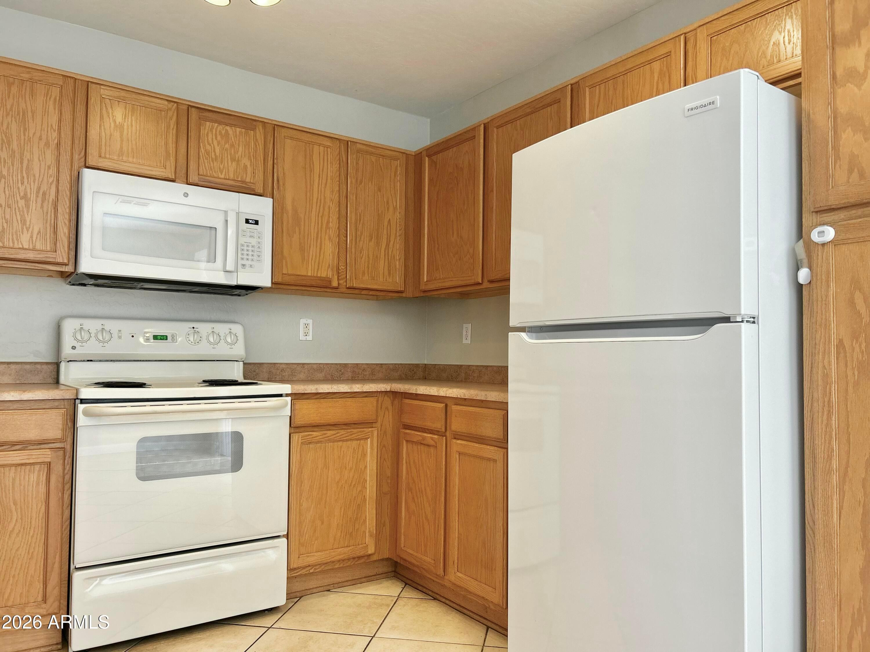 2701 East Bagdad Road San Tan Valley, AZ 85143 - Photo 10 of 21 a kitchen with white cabinets and white appliances