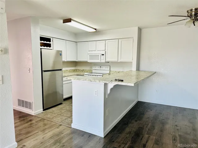 a utility room with cabinets washer and dryer