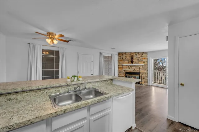 a kitchen that has a sink and a stove in it