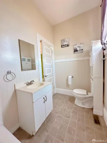 a bathroom with a sink a toilet and a window